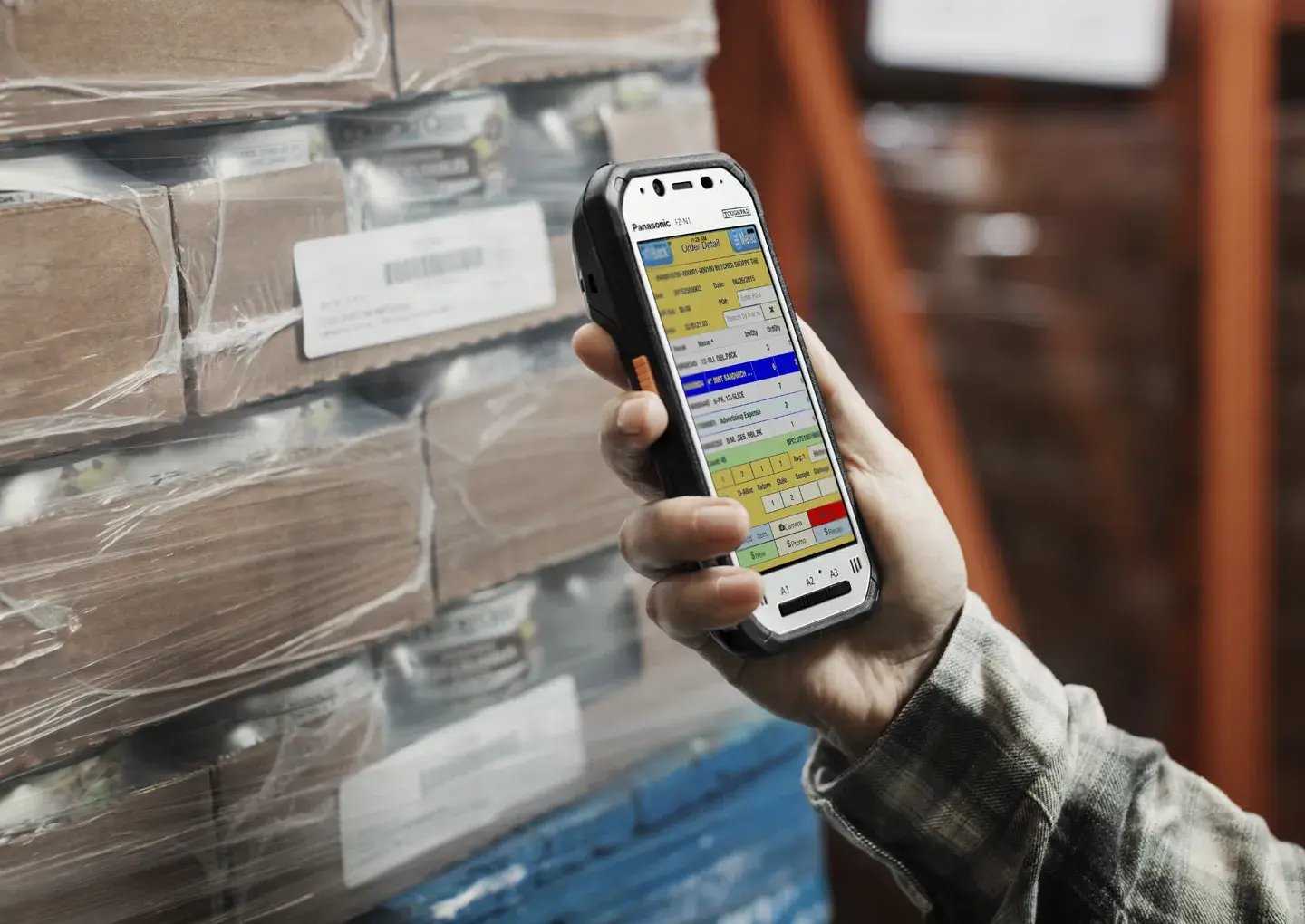 man-in-warehouse-with-handheld-device-closeup