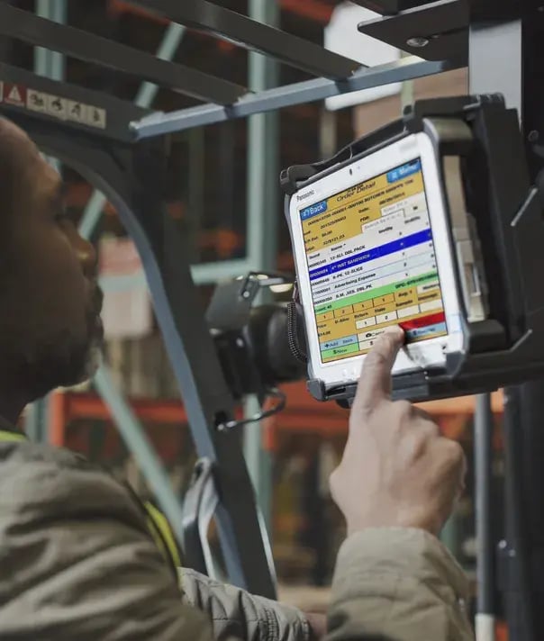man-on-forklift-looking-at-touchscreen