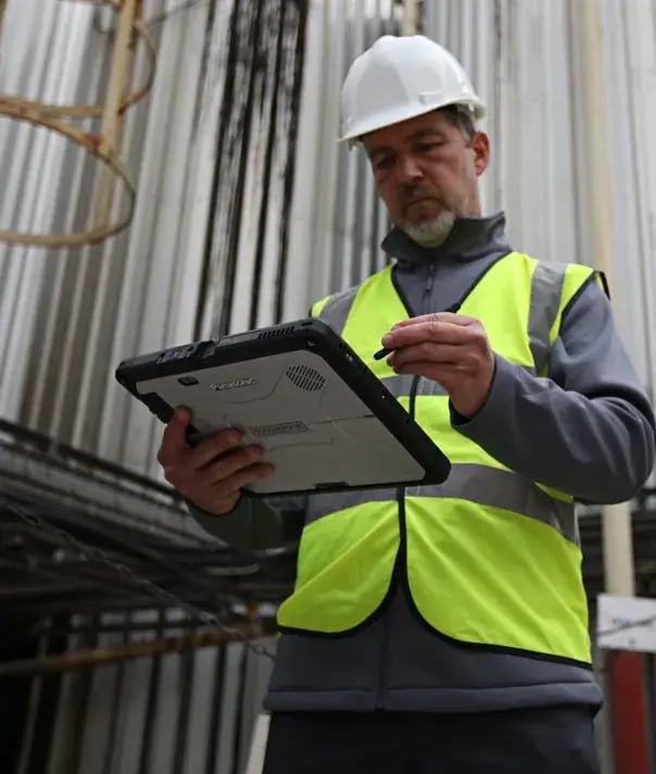 man-with-contruction-hat-using-tablet