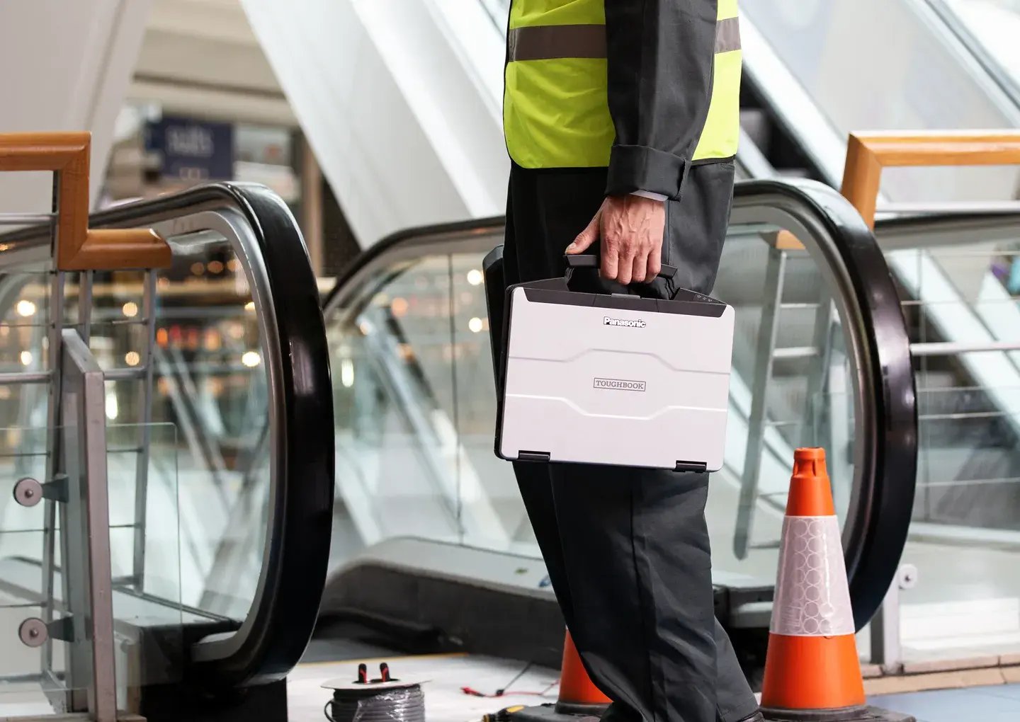 man-with-laptop-by-escalator