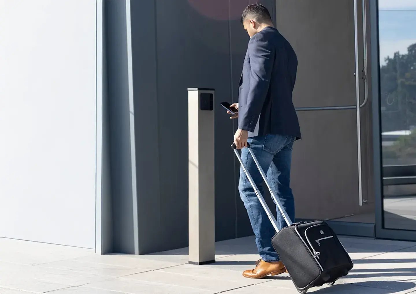 man-with-luggage-on-phone