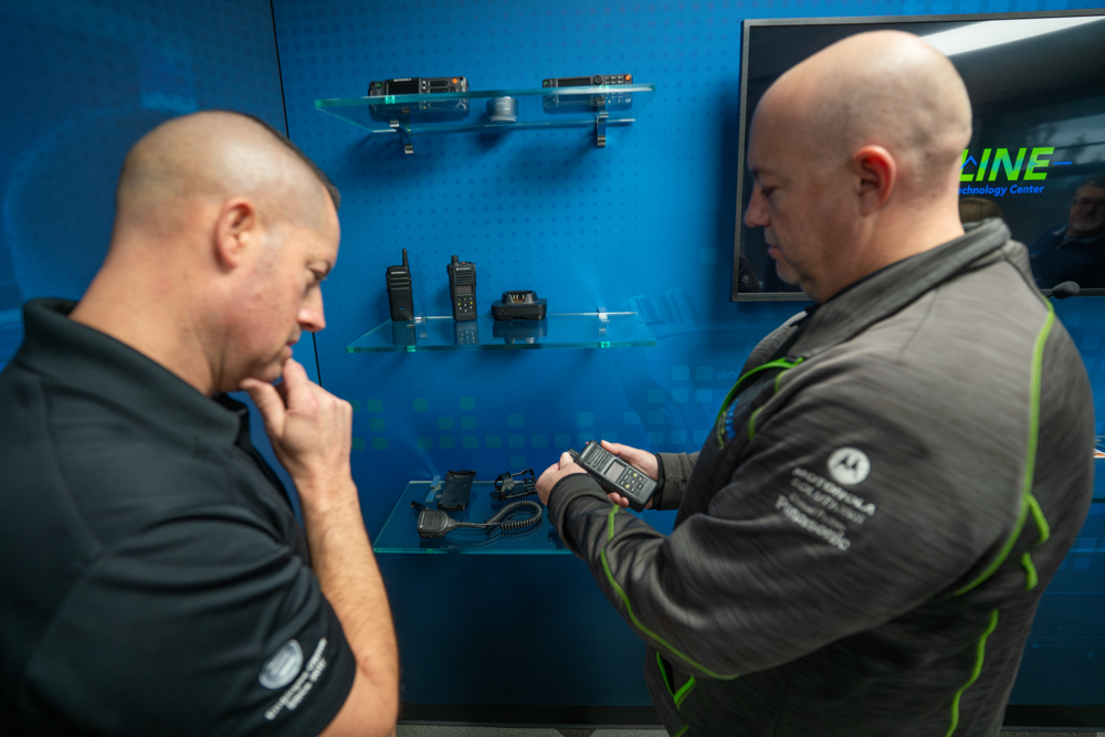 BAYCOM technicians holding radios