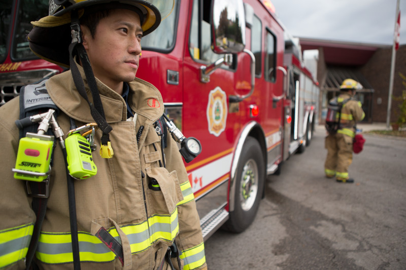 firefighters standing beside a fire engine