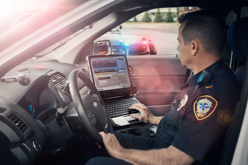 police officer using a law enforcement rugged laptop